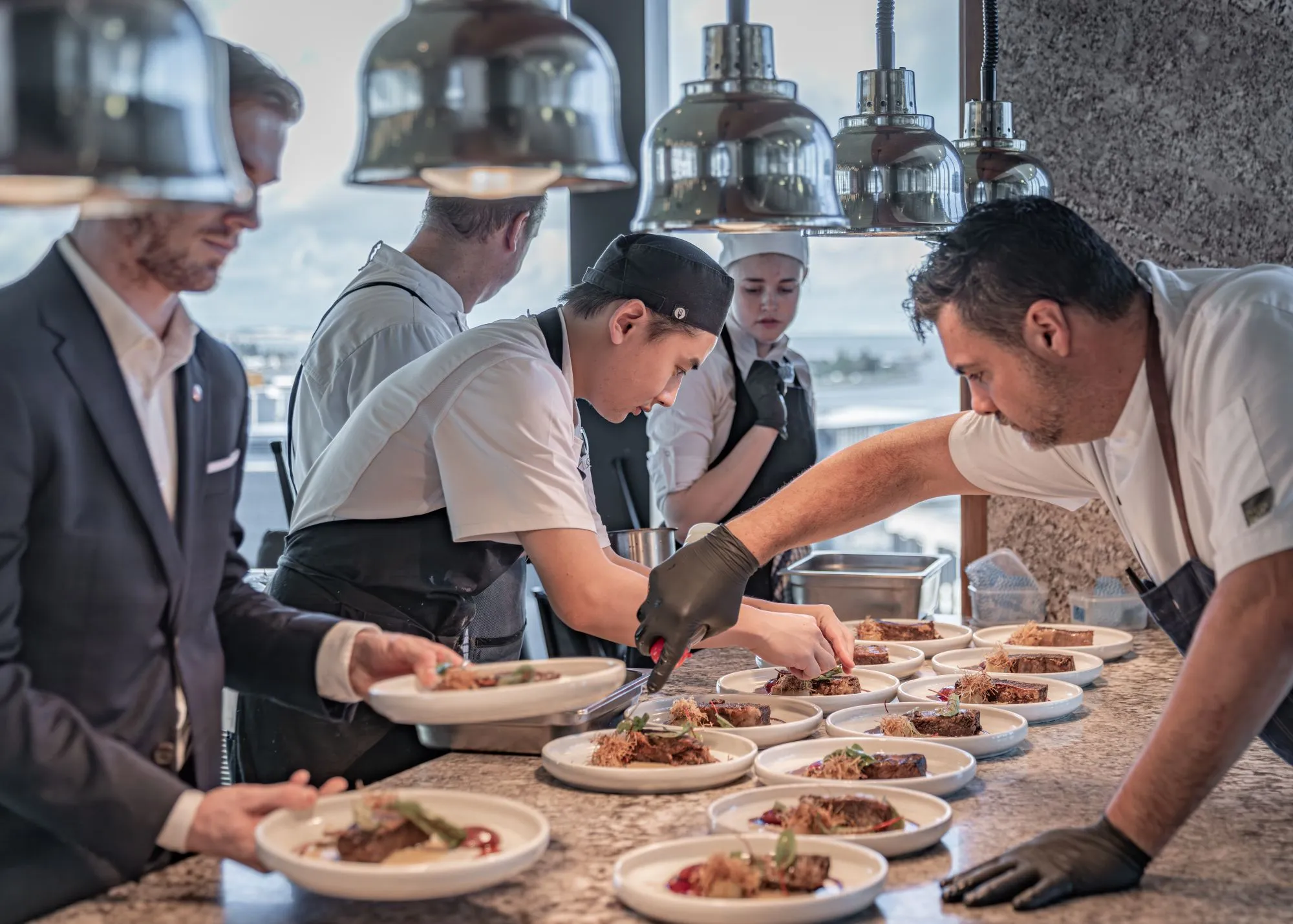 Chefs plating gourmet dishes at Crystalbrook Kingsley during Newcastle Food Month culinary event