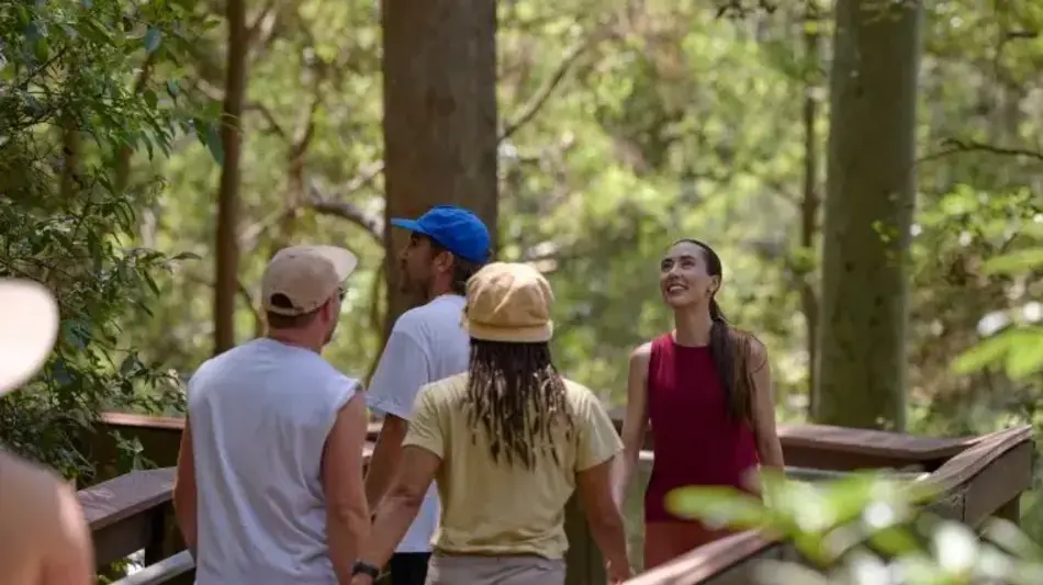 Group of friends walking through Blackbutt Reserve